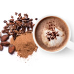 Mug of chocolate drink and cocoa powder with cacao beans isolated on white background. Top view. Flat lay.