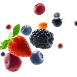 Many different berries in the form of a frame on a white background.